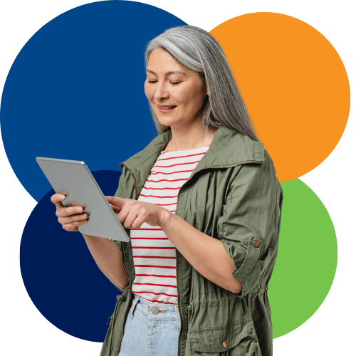 Woman with long silver hair looking at iPad Woman with long silver hair looking at iPad