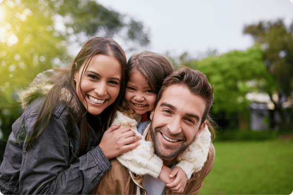 smiling family of three people 