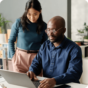 Asian woman and African American man looking at computer
