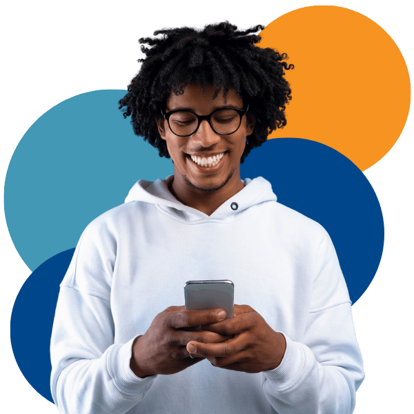 African American man looking at mobile device and smiling African American man looking at mobile device and smiling