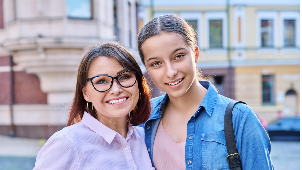 mom and teen daughter smiling 