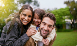 smiling family of three people 