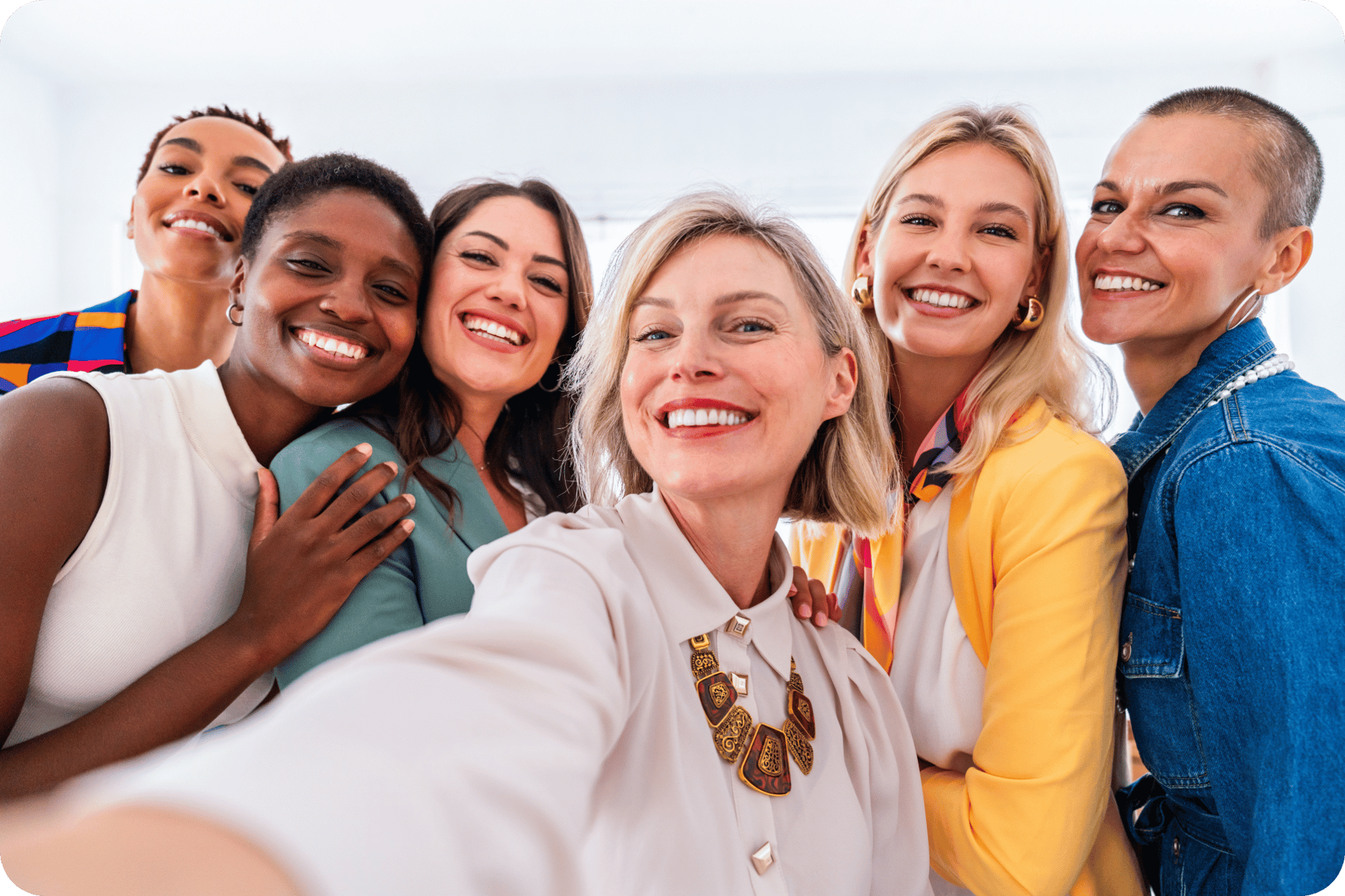 Group of mixed race woman smiling taking a selfie Group of mixed race woman smiling taking a selfie