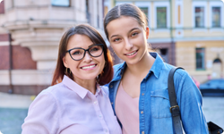 smiling mom and teen daughter 