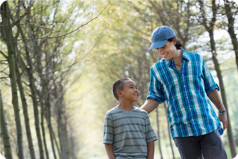 Man and boy walking together outside Man and boy walking together outside