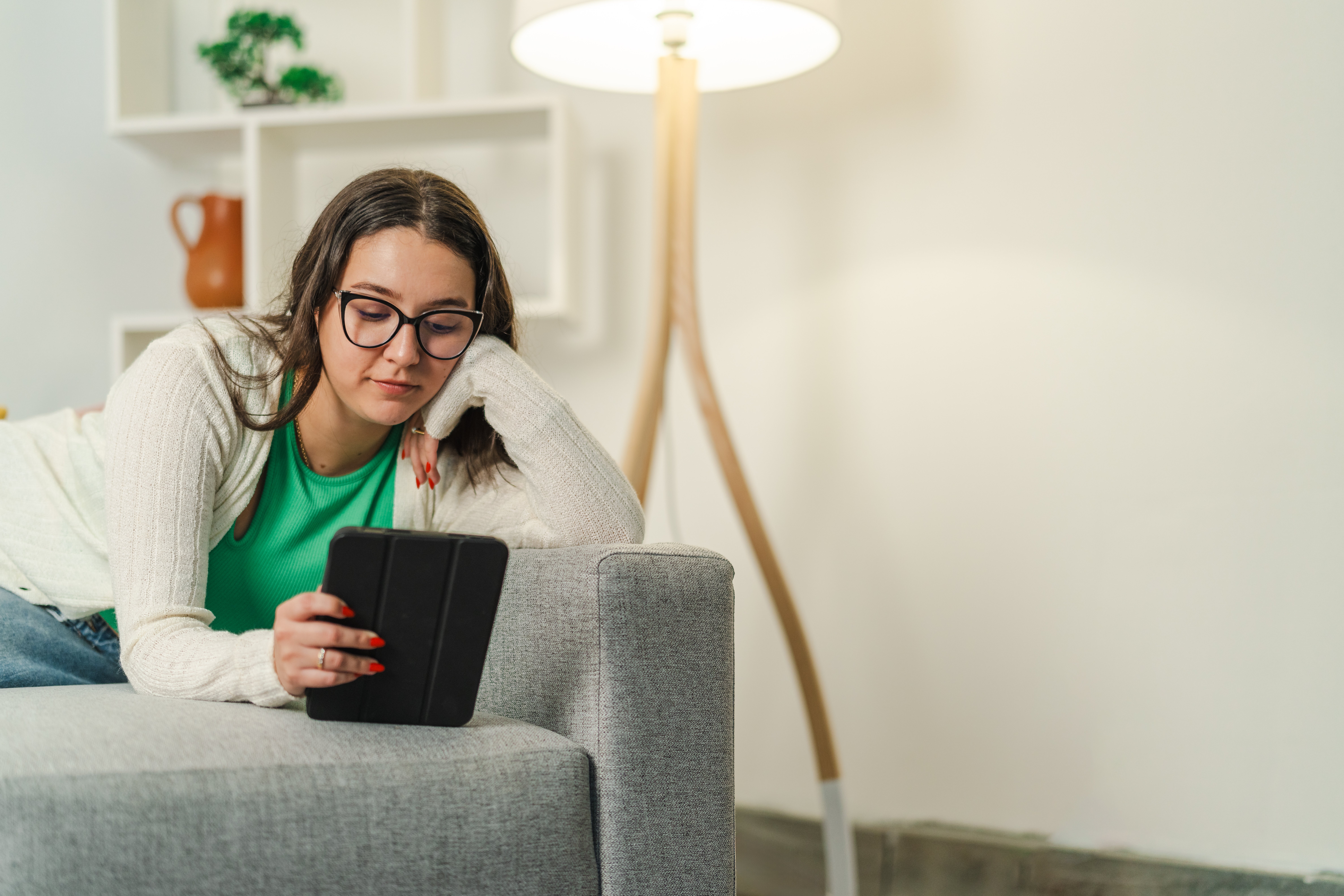 Woman reading a tablet at home