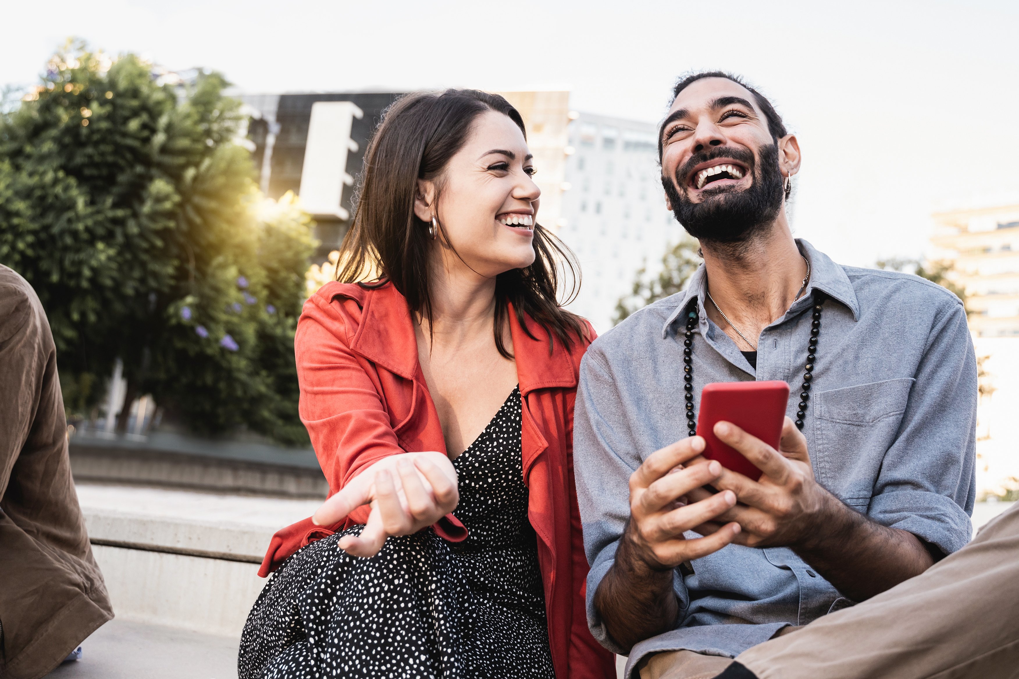 man with cell phone and woman smiling 